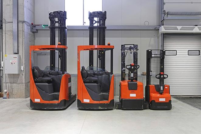 electric forklifts moving supplies in eco-friendly warehouse